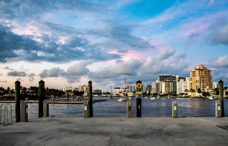 Waterfront view of Fort Lauderdale with luxury buildings, boats, and a scenic sky, highlighting the area's upscale construction opportunities.